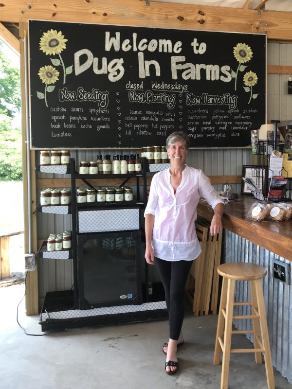 Carolyn Quinn posing in front of counter with products behind them