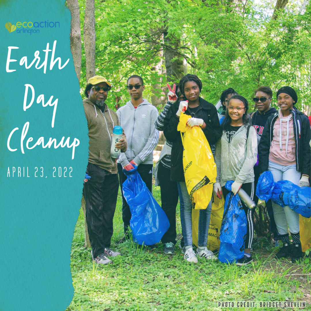 volunteer group shot in the park wth volunteers holding bags of trash