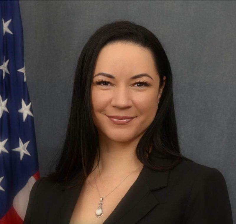 Headshot of Charisa Morris with American flag on flagpole in background