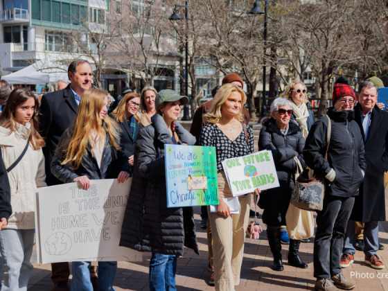 photo of crowd at the 2/22/25 Climate Resolution Rally holding signs and listening attentively. Photo credit: @elmanstudio